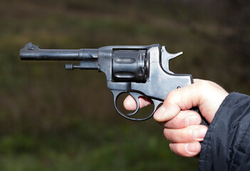 Pistol Nagant revolver in hand gangster