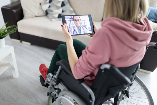 Woman in wheelchair holding tablet with picture closeup