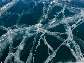 Network of cracks in thick solid layer of ice of a frozen Baikal lake in Siberia (Russia)