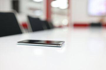 Mobile touchscreen phone lying on table in office