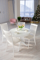 Luxury rich expensive apartment interior in light colors. Stylish contemporary minimalistic design. Full of sun light. A lot of space decorated with Christmas tree