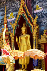 Golden statue of buddha in temple, Thailand	