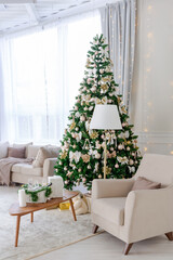 Luxury rich expensive apartment interior in light colors. Stylish contemporary minimalistic design. Full of sun light. A lot of space decorated with Christmas tree