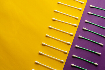 Minimalist background with cotton swabs on a lilac-yellow background.