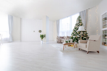 Luxury rich expensive apartment interior in light colors. Stylish contemporary minimalistic design. Full of sun light. A lot of space decorated with Christmas tree