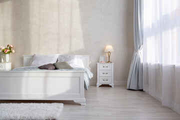Stylish modern bedroom with a minimalistic design in a luxurious rich, expensive interior of an open-plan apartment in light colors. © 4595886