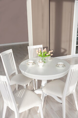 Luxurious and expensive interior of an open-plan apartment in light colors. Stylish modern bedroom with minimal design, dining area and guest space.