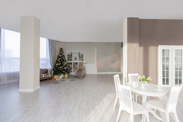 Luxury rich expensive apartment interior in light colors. Stylish contemporary minimalistic design. Full of sun light. A lot of space decorated with Christmas tree