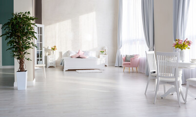 Stylish modern bedroom with a minimalistic design in a luxurious rich, expensive interior of an open-plan apartment in light colors.
