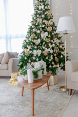 Luxury rich expensive apartment interior in light colors. Stylish contemporary minimalistic design. Full of sun light. A lot of space decorated with Christmas tree