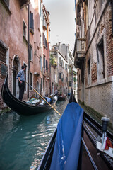 The gondolier floats on a gondola with tourists