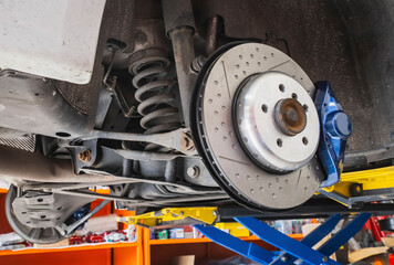 brake disc and shock absorber in the  disassembled car in the workshop