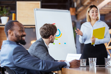 Success. Diverse group of co-workers having casual discussion in office. Executives during friendly discussion, month reporting, creative meeting. Concept of business, finance, occupation, job.