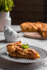 Homemade apple pie with mint leaves on a plate