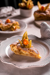 Homemade apple pie with fisalis on a plate