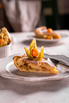 Homemade apple pie with fisalis on a plate