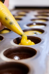 pouring the filling into candies during the manufacturing process