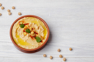 Hummus in plate on wooden table, dip food