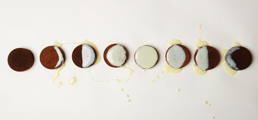 Moon phase diagram laid out of coffee espresso pucks and milk on white background. Top view,...
