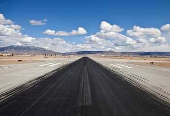 Dark skid marks on a busy desert airport runway.