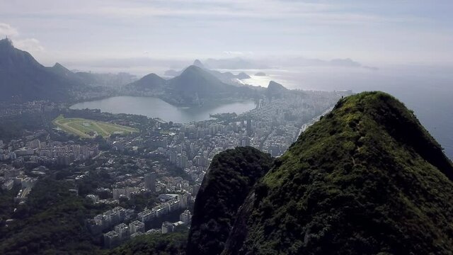 Aerial drone revealing shoot of city of Rio de Janeiro with mountains, Christ the Redeemer, Lagoa Rodrigo de Freitas and Ipanema Beach.