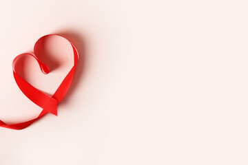 Heart from red ribbon on white desk background. Concept Valentines day, date planning, February 14, romantic. Flatlay, copyspace