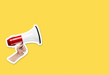Hand holding megaphone on bright yellow background with plenty of copy space. Magazine collage cut...