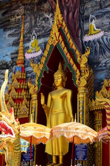 Golden statue of buddha in temple, Thailand	