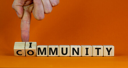 Community immunity symbol. Doctor turns cubes and changes the word 'community' to 'immunity'. Beautiful orange background, copy space. Business, medical and community immunity covid-19 concept.