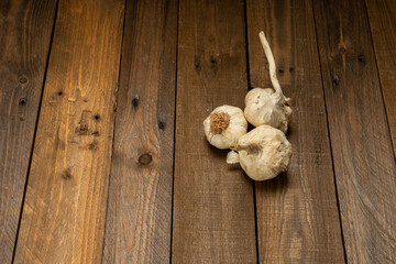 Organic garlic on wooden background