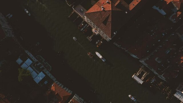 Beautiful panoramic aerial drone footage of iconic and unique grand canal and boats in Venice during sunset.	