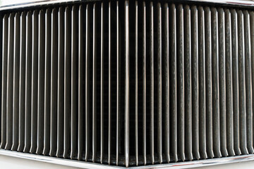 Full screen chrome grille of a vintage retro car.