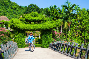 April 19, bicycle day, a girl on a bicycle travels in Vietnam,