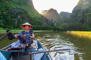 On the Tam Coc river you can go on a 2 hour boat ride where the rowers mostly women have perfected...