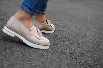 Woman walking outdoors, closeup. space for text