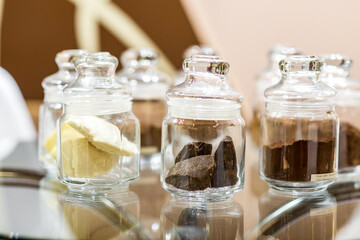 Regular and alkalised cocoa powder on with dar chocolate, in glass jars with lids.