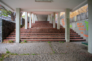 Empty hall with stairs and surrounded by columns