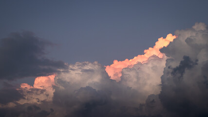 Top of cumulus cloud. Dramatic sky before storm. Cumulonimbus during sunset