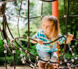 Girl climbing on jungle gym