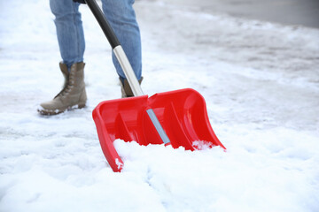 Person shoveling snow outdoors on winter day, closeup © New Africa