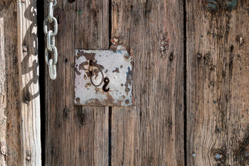 Close-up detail of vintage entrance door panels lock and chain