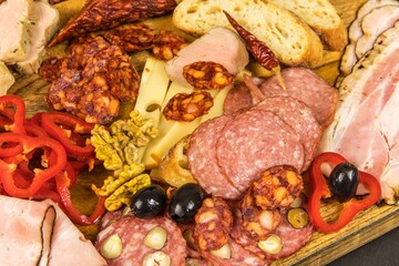 Various kind types of salami, speck and sausages on a wooden table. Fat junk food. Smoked meat. Obesity concept. Overweight.