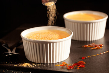 Creme brulee - traditional french vanilla cream dessert on dark background.