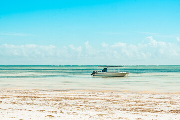 Small motor boat on the shallows on the beach