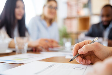 Close up hands of co-workers during casual discussion in office. Executives during brainstorming,...