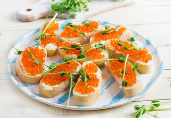 Canape with salmon red caviar. Sandwich for lunch. Delicious food.
