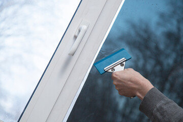 Installation of window film in the office. Protection from ultraviolet radiation.