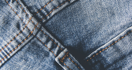 Denim blue jeans texture with scuffs and holes. Abstract background.