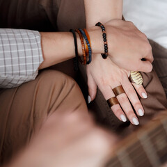 Hands of couple man and woman with jewelry rings  and bracelets