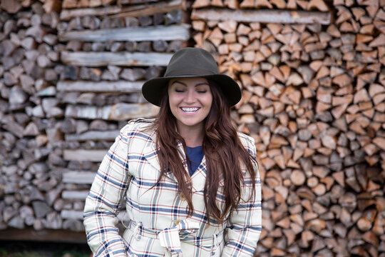 A young red head woman laughing and looking bashful
